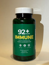 Load image into Gallery viewer, 92+ Immune Sea Moss Capsules bottle on wooden surface with yellow background