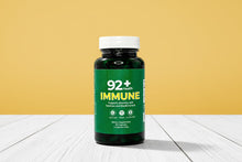Load image into Gallery viewer, 92+ Immune Sea Moss Capsules bottle supporting immune health with Irish Sea Moss and Bladderwrack on a wooden surface
